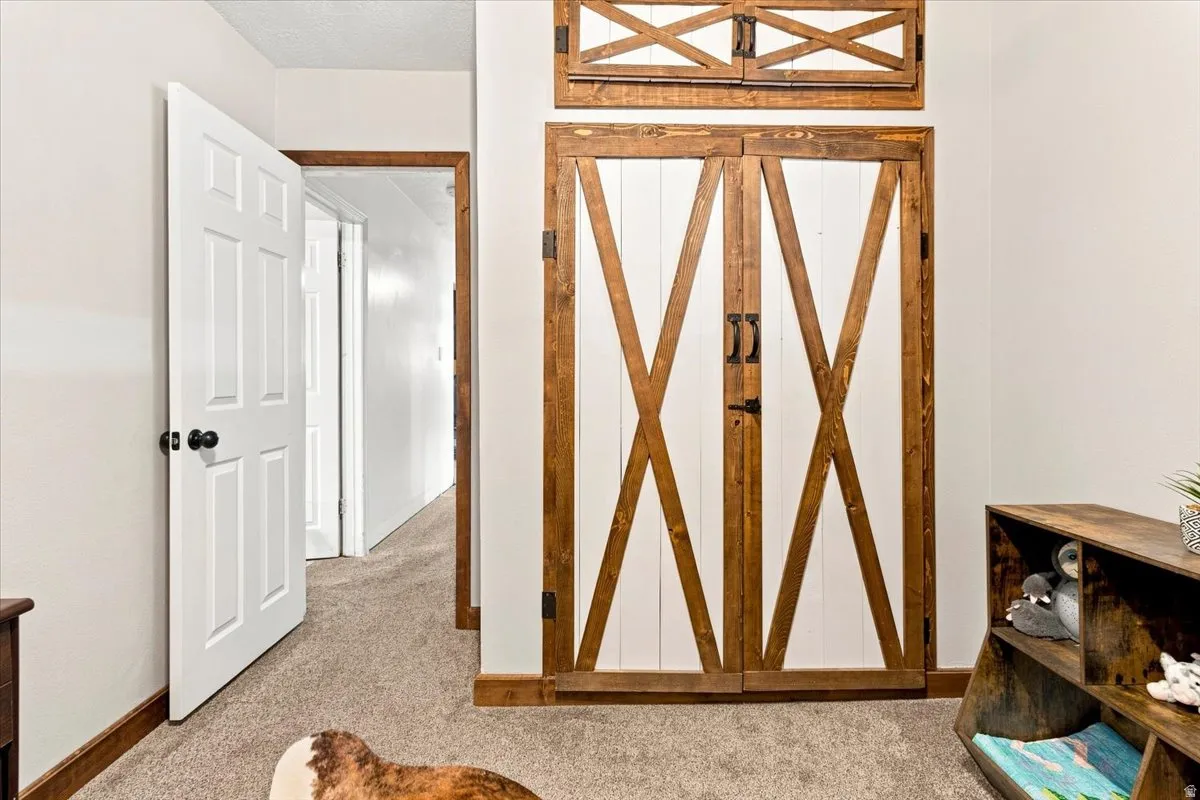 Custom-built barn doors with crossbuck detailing and dark hardware