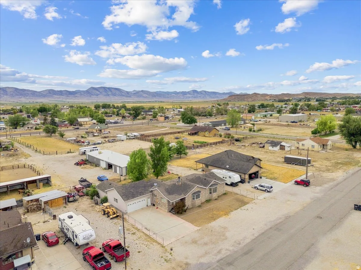 Aerial perspective showcasing a residential property with a multi-car driveway and an attached garage