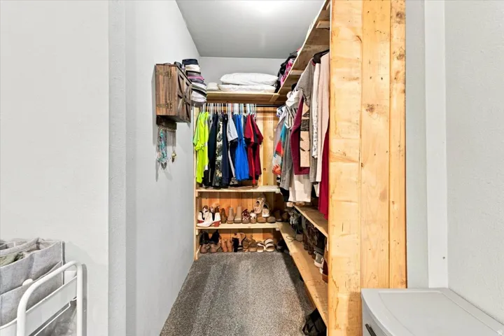 Custom wood-finish closet system featuring integrated shelving and hanging rods