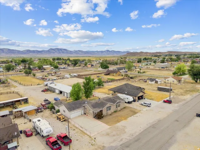 Aerial perspective showcasing a residential property with a multi-car driveway and an attached garage
