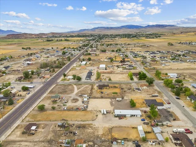 Expansive aerial perspective showcasing a rural community with varied lot sizes and a prominent two-lane highway