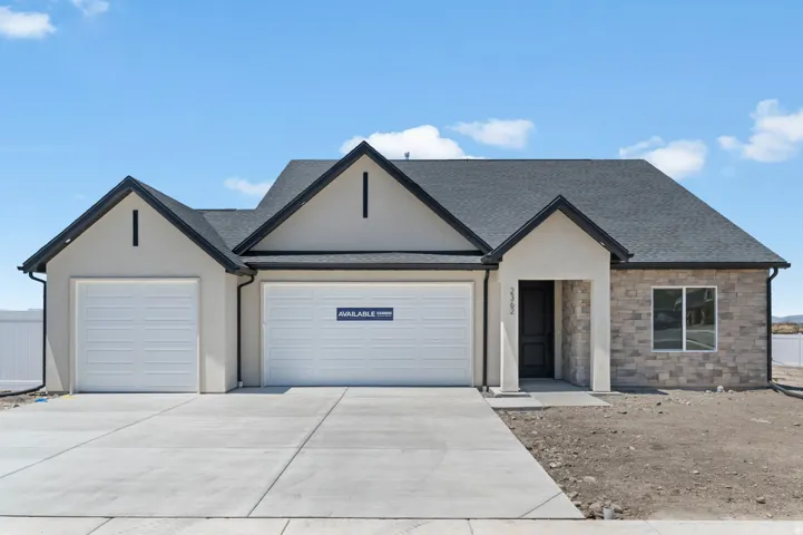 Modern stucco and stone-clad exterior with a dark asphalt shingle roof