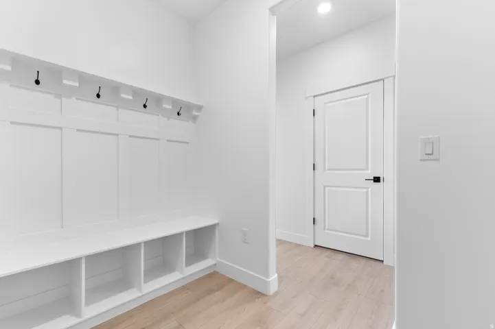Built-in mudroom bench with cubby storage and coat hooks