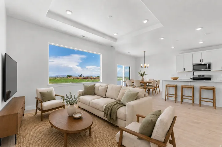 Spacious living area with recessed lighting, wood-finish flooring, and a large picture window