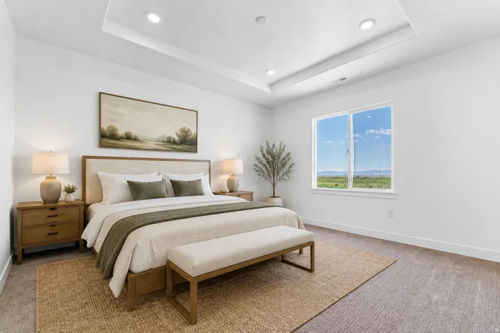 Recessed tray ceiling with integrated lighting, expansive window with natural scenery, and wood-finish nightstands