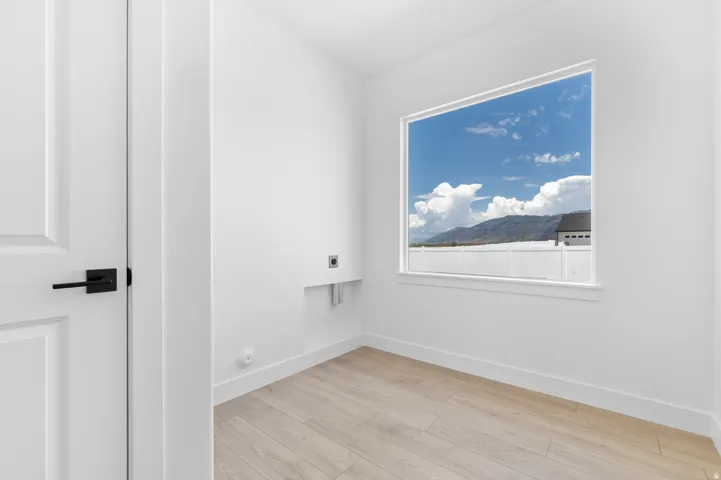 Bright room with a large window and light wood-finish flooring