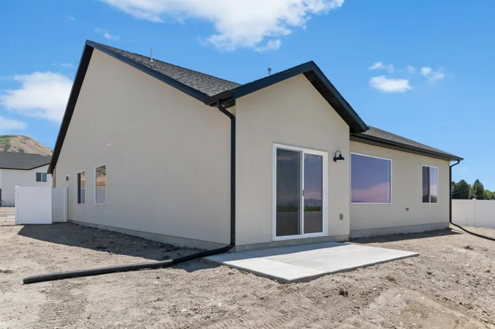 Contemporary exterior with stucco siding and black trim accents