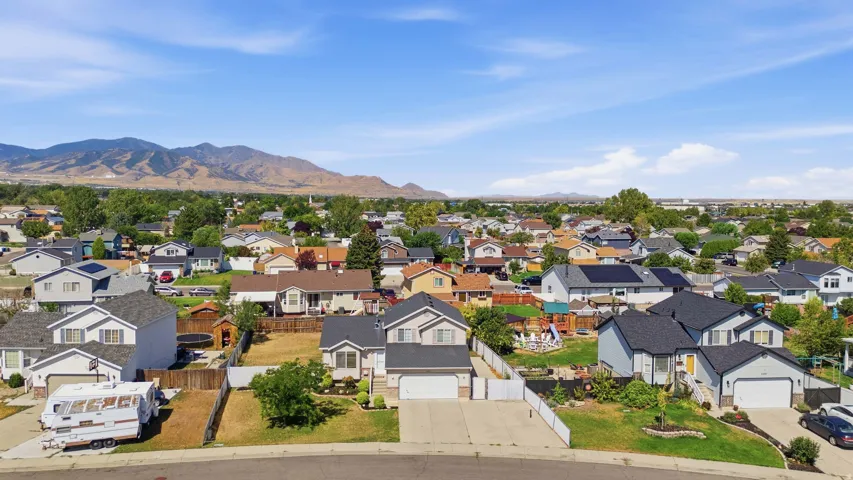 Aerial perspective showcasing a residential neighborhood with distant mountain ranges