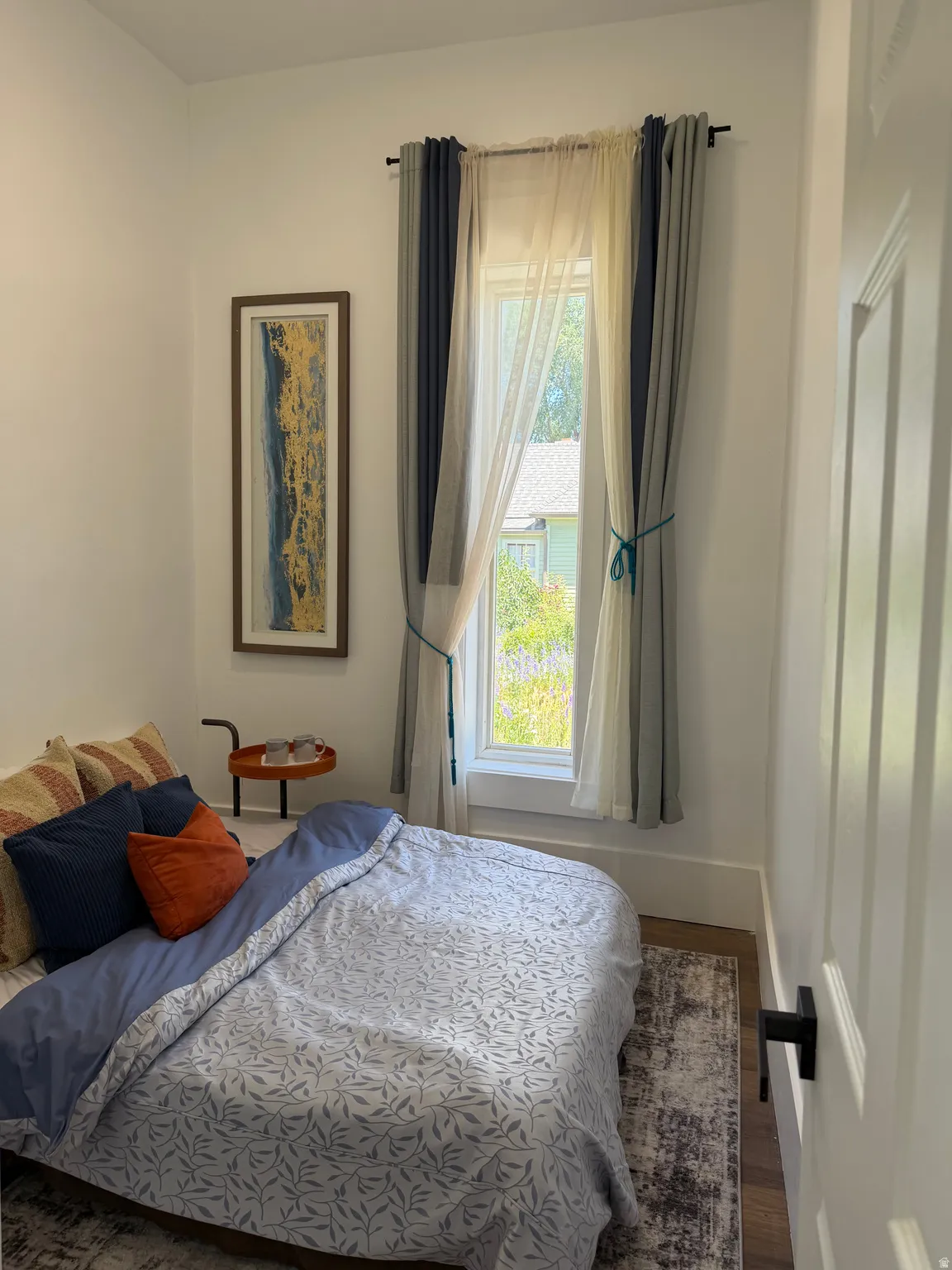 White walls and wood-finish flooring provide a neutral backdrop