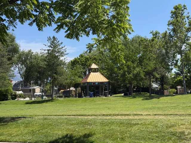 Expansive green space featuring a central gazebo with a copper-toned roof