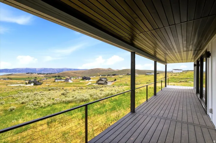 Expansive covered patio featuring composite decking and sleek cable railings