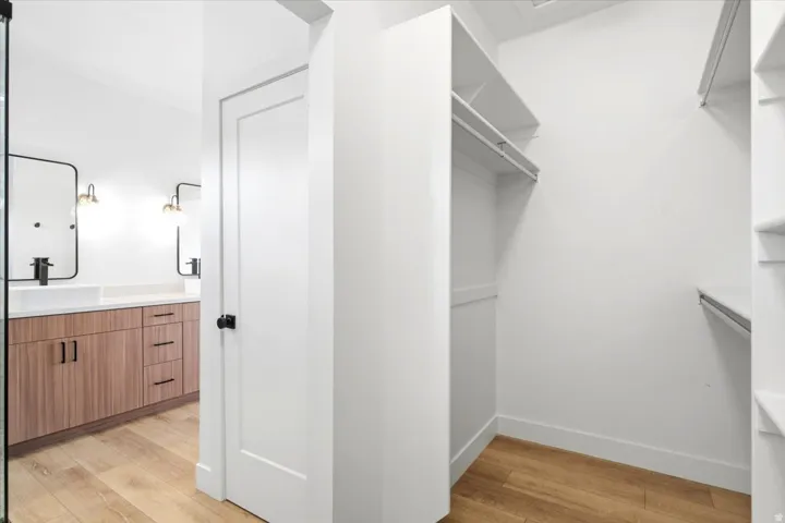 Spacious walk-in closet with ample shelving and hanging rods