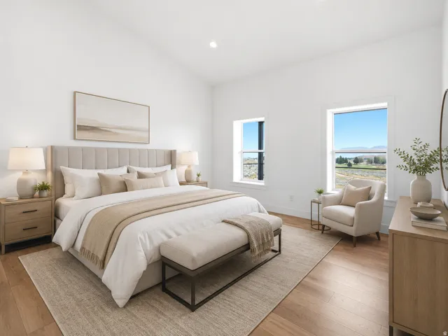 Vaulted ceiling bedroom featuring wood-finish flooring, two large windows, and recessed lighting