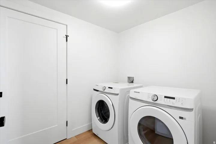 Dedicated laundry area featuring a front-load washer and dryer set
