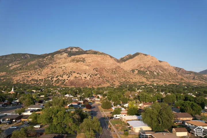 Elevated mountain backdrop overlooking a residential area with mature tree coverage