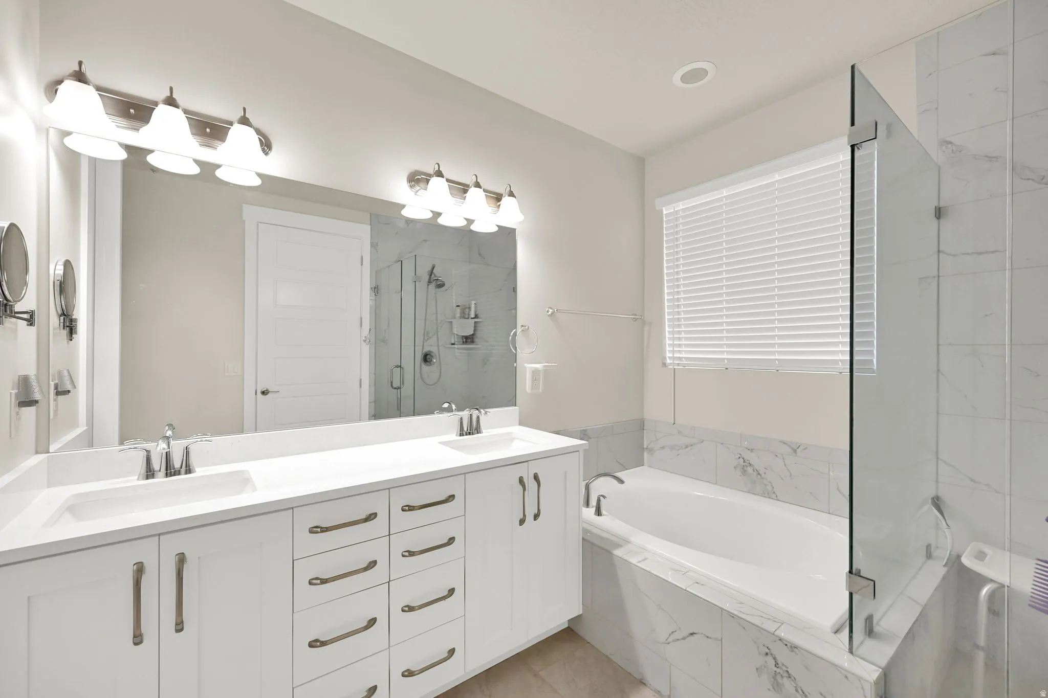 Dual vanity with undermount sinks and white shaker-style cabinetry