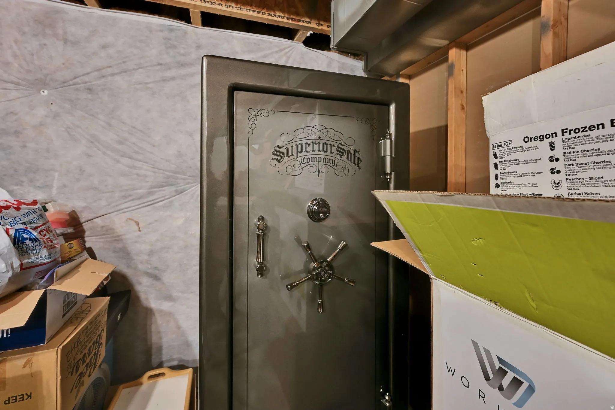 Basement utility space featuring a large, grey Superior Safe Company safe
