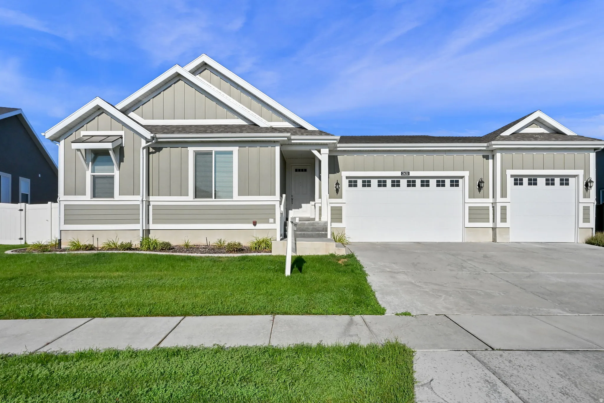 Contemporary residence featuring light gray siding with white trim accents