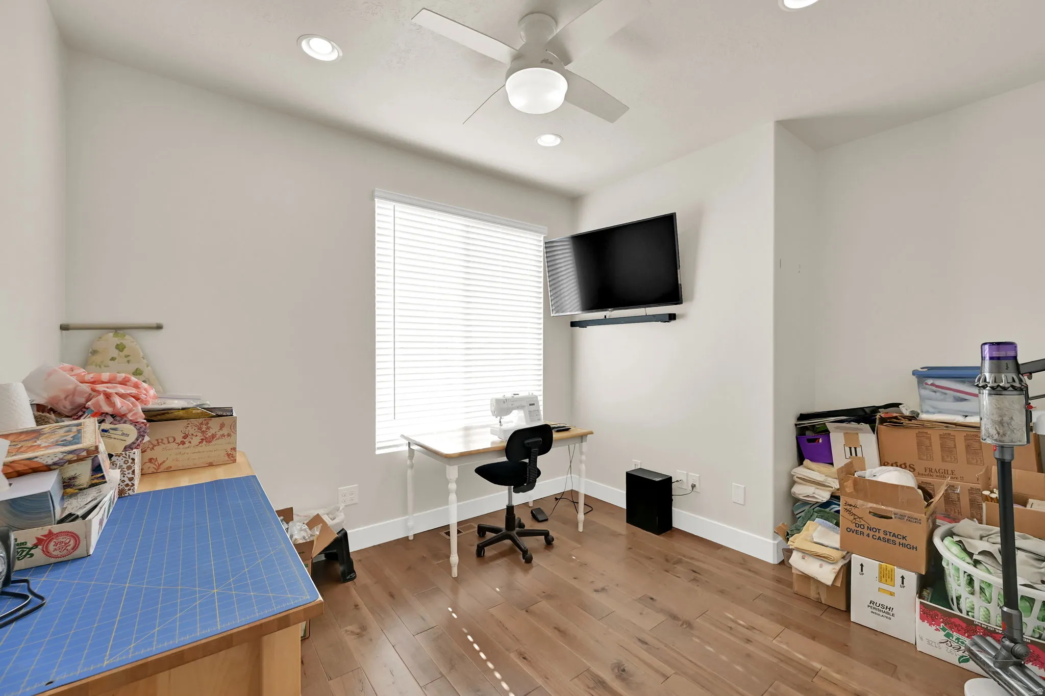 Room featuring wood-finish flooring, recessed lighting, and a ceiling fan
