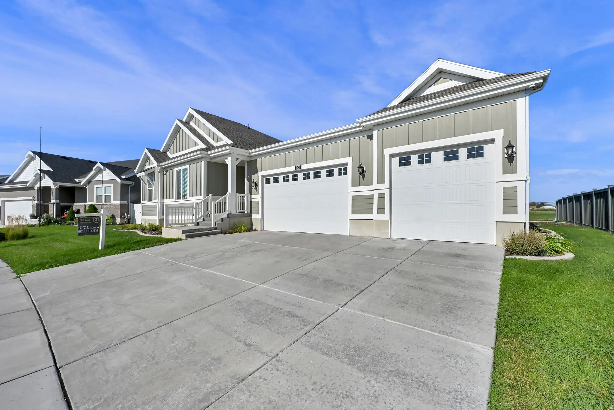 Single-story residence featuring a gabled roofline, light gray siding, and white trim