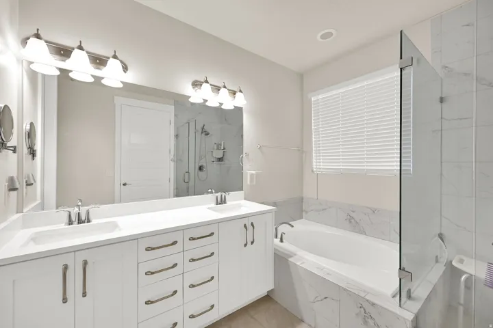 Dual vanity with undermount sinks and white shaker-style cabinetry