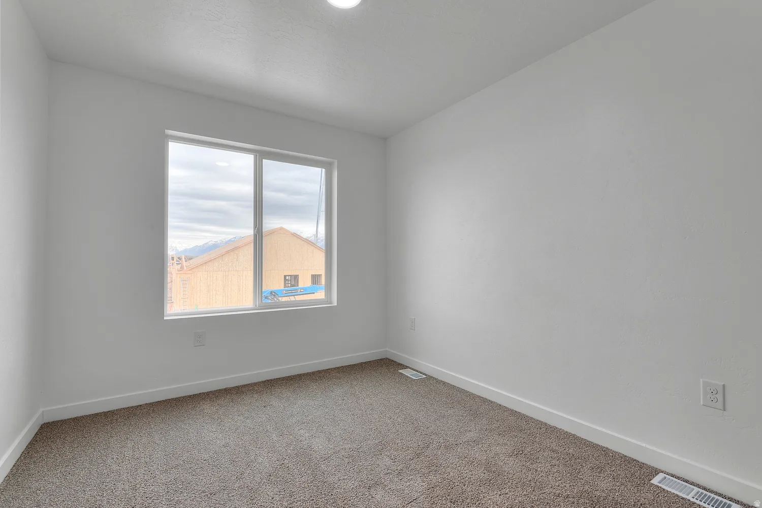 Neutral white walls paired with a large window