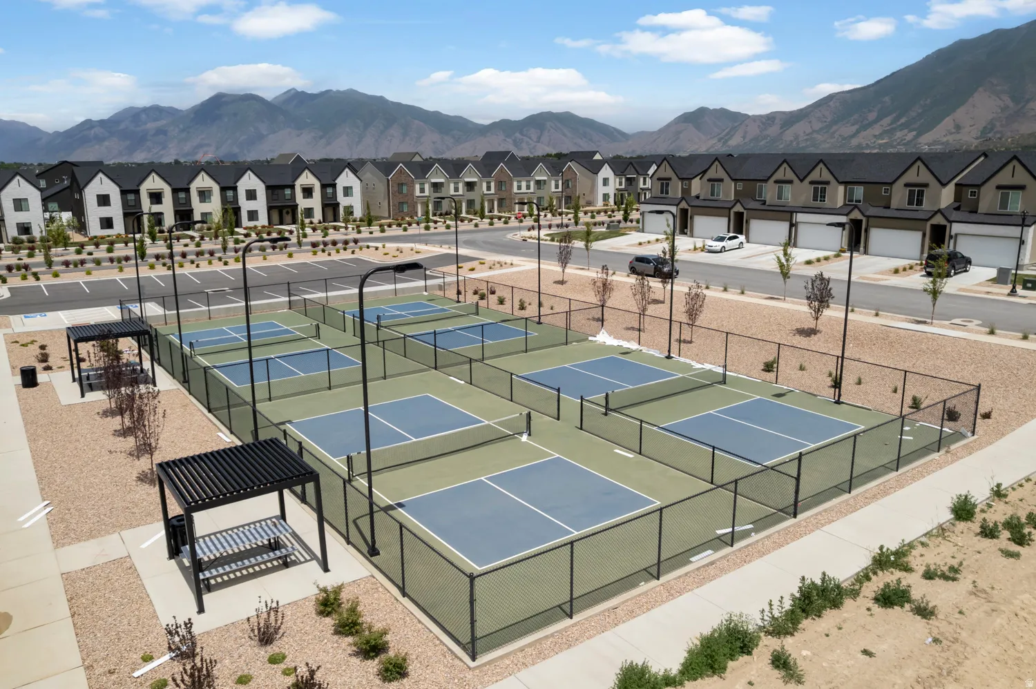 Multiple pickleball courts with perimeter fencing