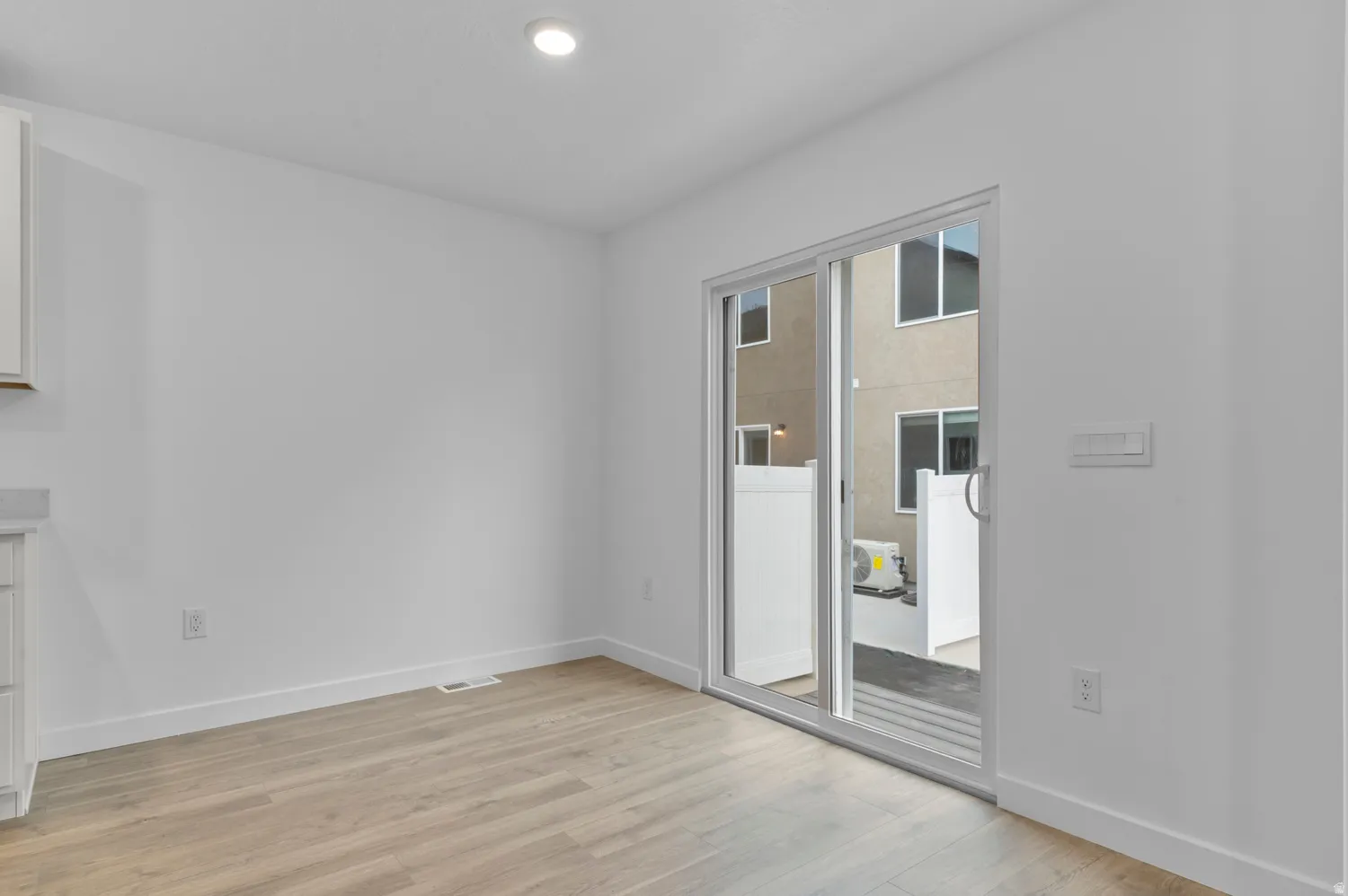 Bright interior space featuring wood-finish flooring, white walls, and recessed lighting