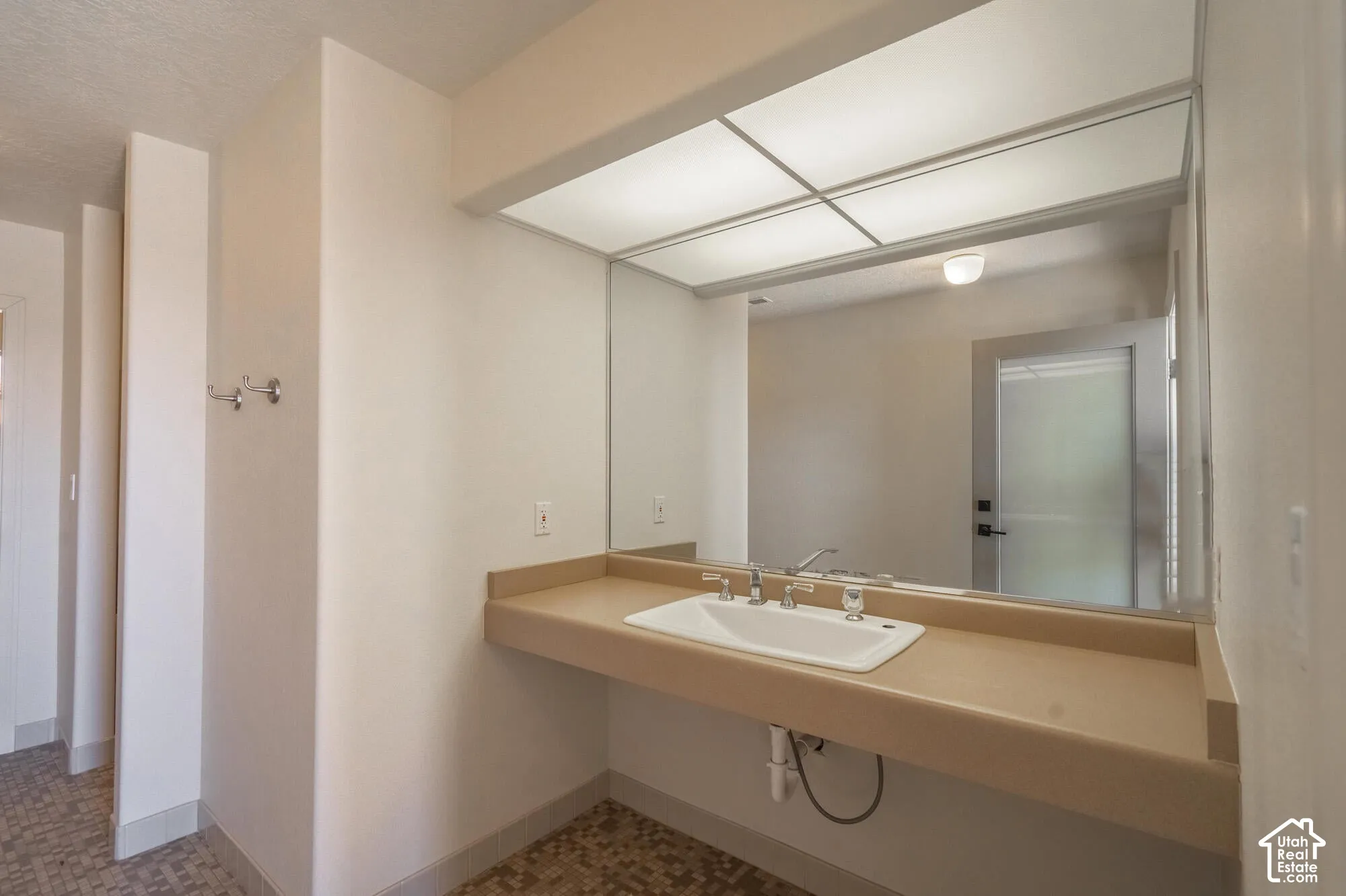 Floating vanity with integrated sink and chrome faucet