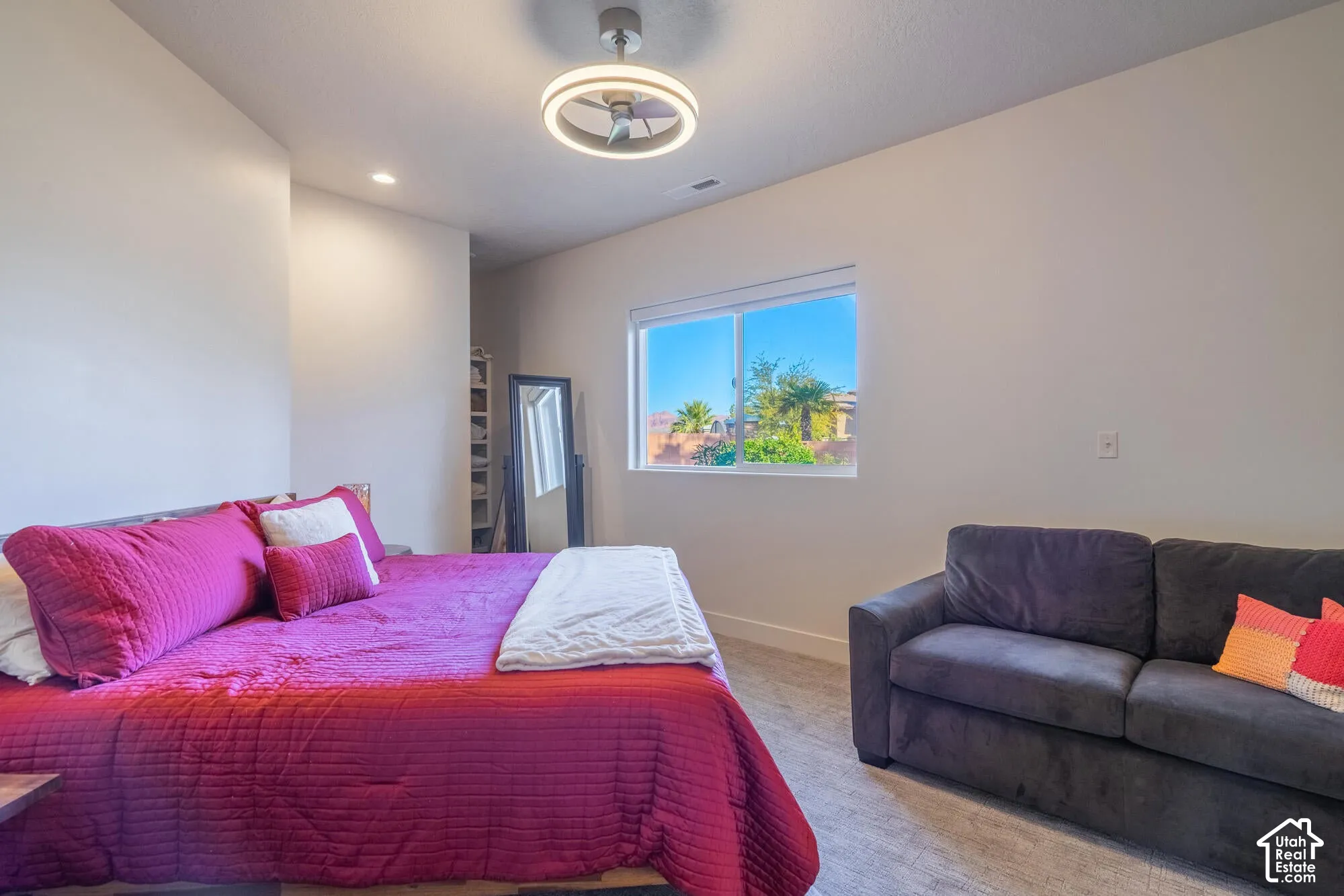 Interior room featuring a large window, a modern ceiling fan with integrated lighting, and recessed ceiling lighting