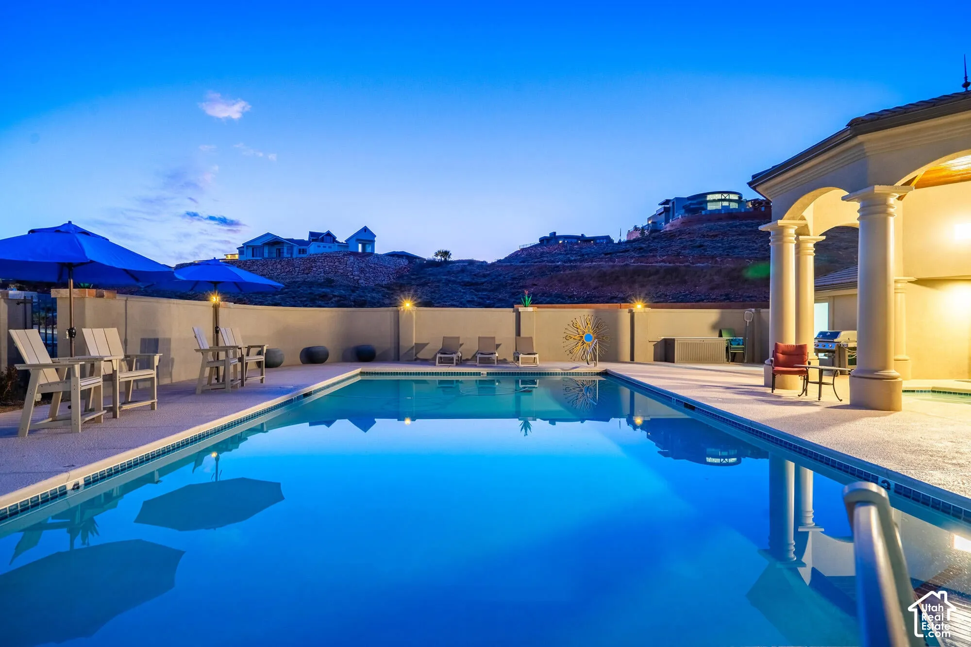 Rectangular swimming pool with integrated spa and surrounding concrete decking