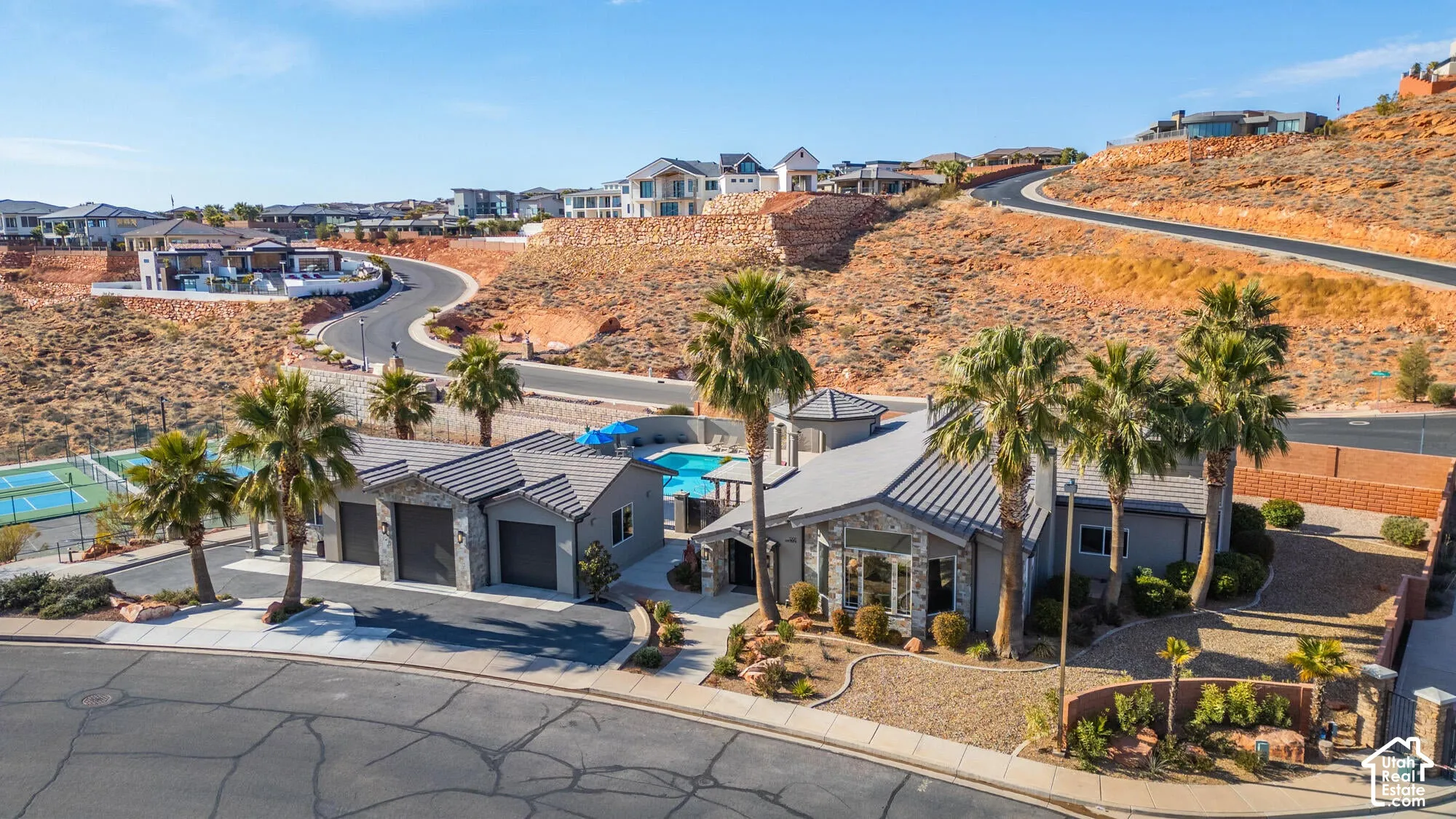Modern-style residence featuring a distinctive roofline, integrated two-car garage, and a swimming pool