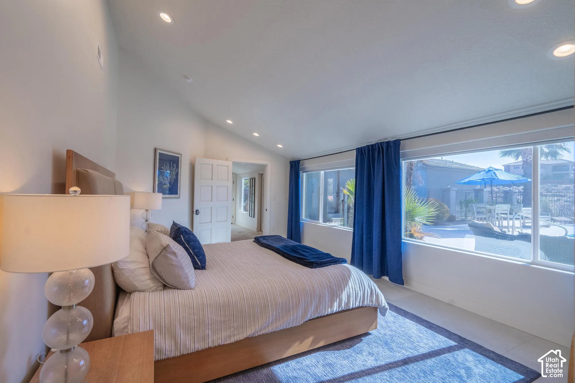 Vaulted ceilings with recessed lighting complement expansive windows offering direct outdoor access