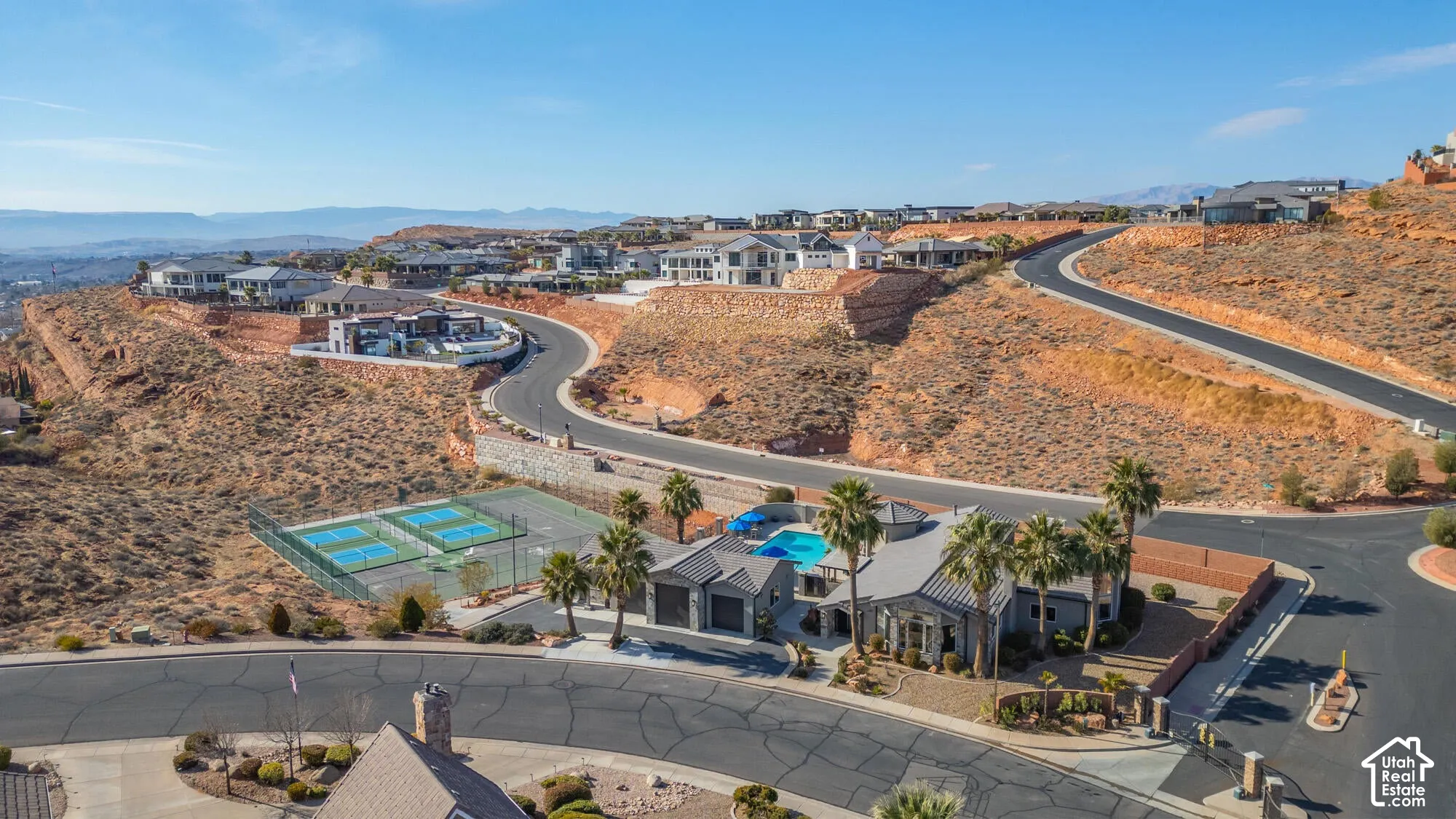 Community amenities featuring a swimming pool, multiple tennis courts, and mature palm trees