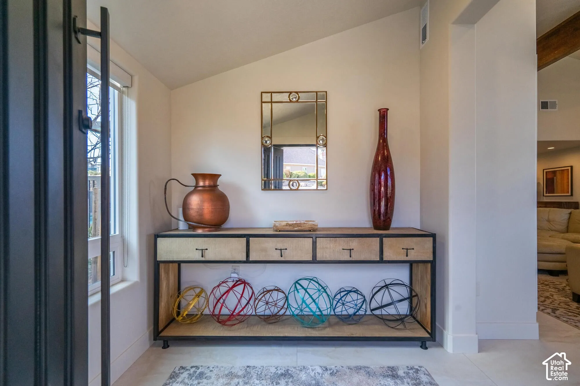 Foyer featuring a vaulted ceiling and light-colored flooring