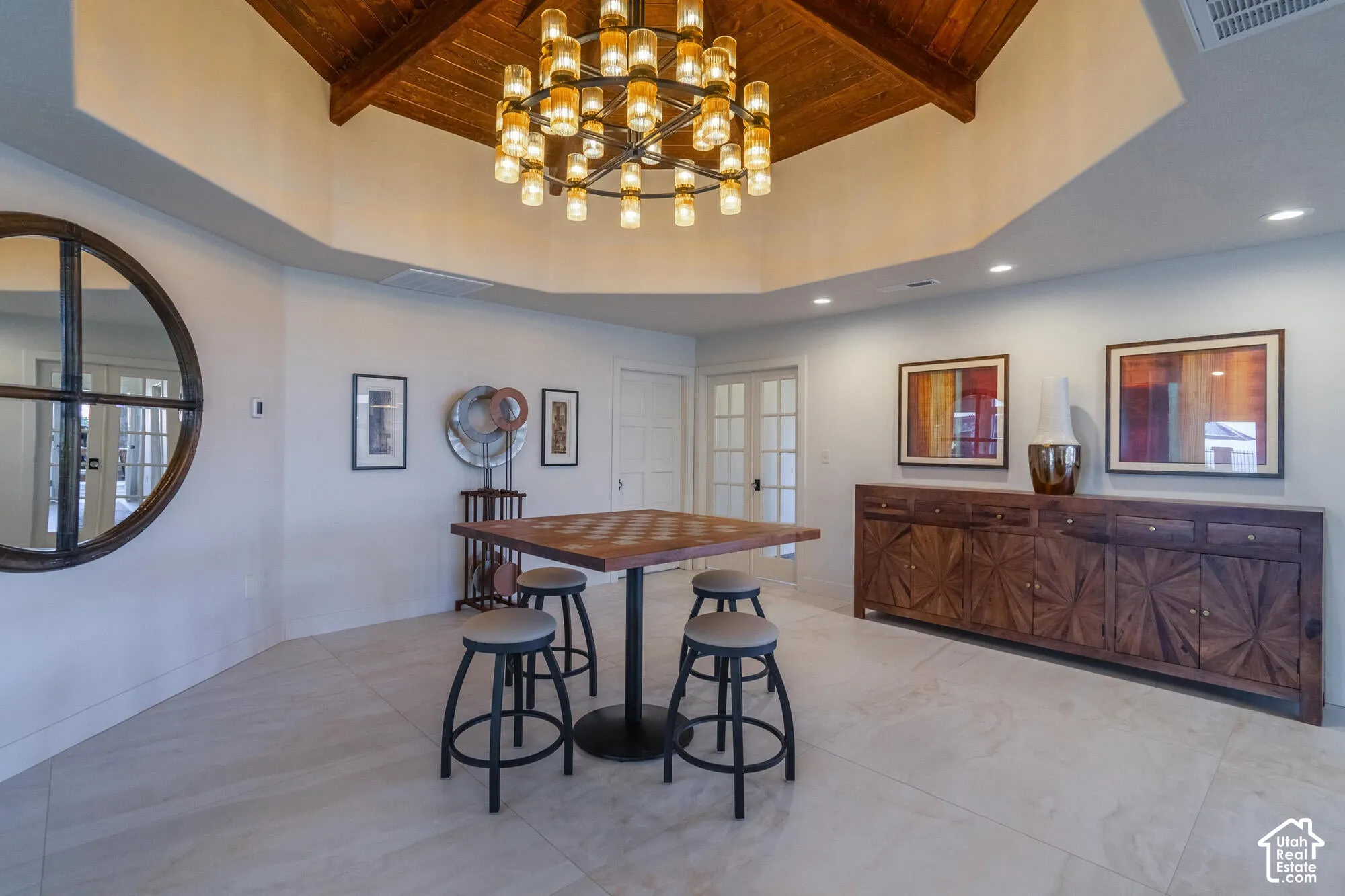Vaulted wood-paneled ceiling with a tiered chandelier
