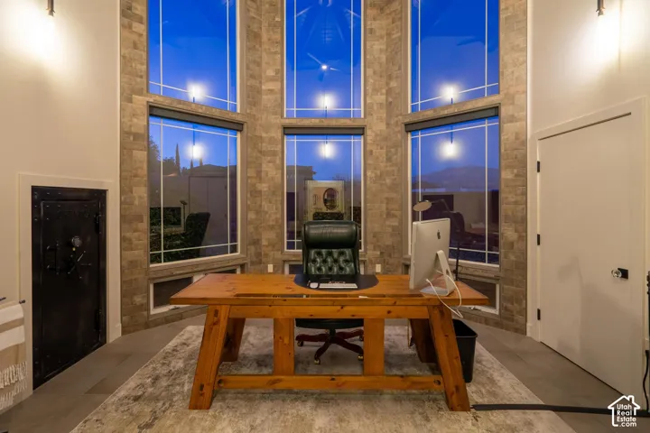 Floor-to-ceiling windows with integrated window treatments, showcasing a stone-clad accent wall