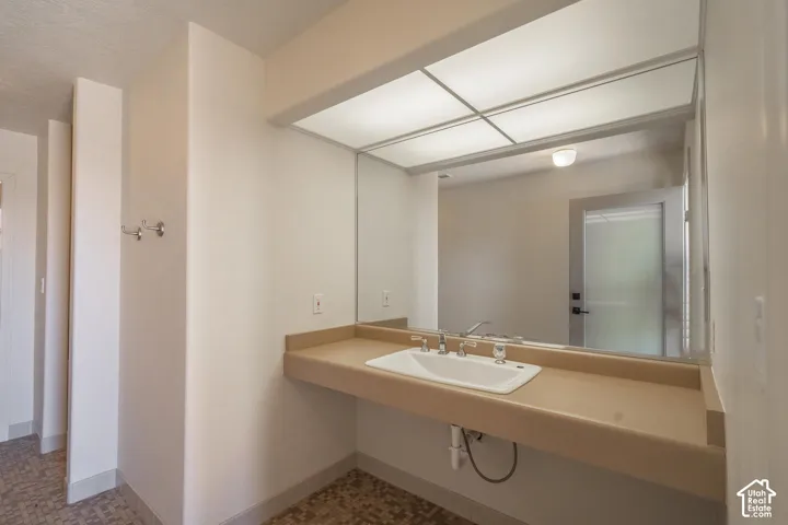 Floating vanity with integrated sink and chrome faucet