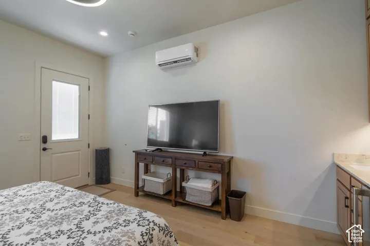 Light wood-finish flooring complements the neutral wall color