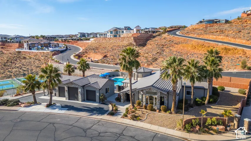 Modern-style residence featuring a distinctive roofline, integrated two-car garage, and a swimming pool