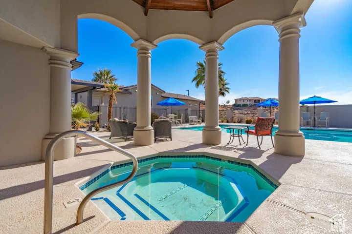 Covered outdoor spa with integrated steps and a stainless steel grab rail