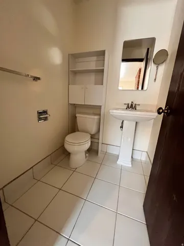 East Side - Pedestal sink with an integrated basin, paired with a wall-mounted mirror