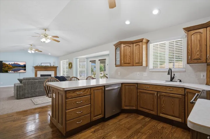 Kitchen featuring wood-finish cabinetry, light-toned countertops, and stainless steel appliances