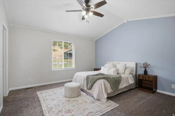 Vaulted ceiling bedroom with a ceiling fan