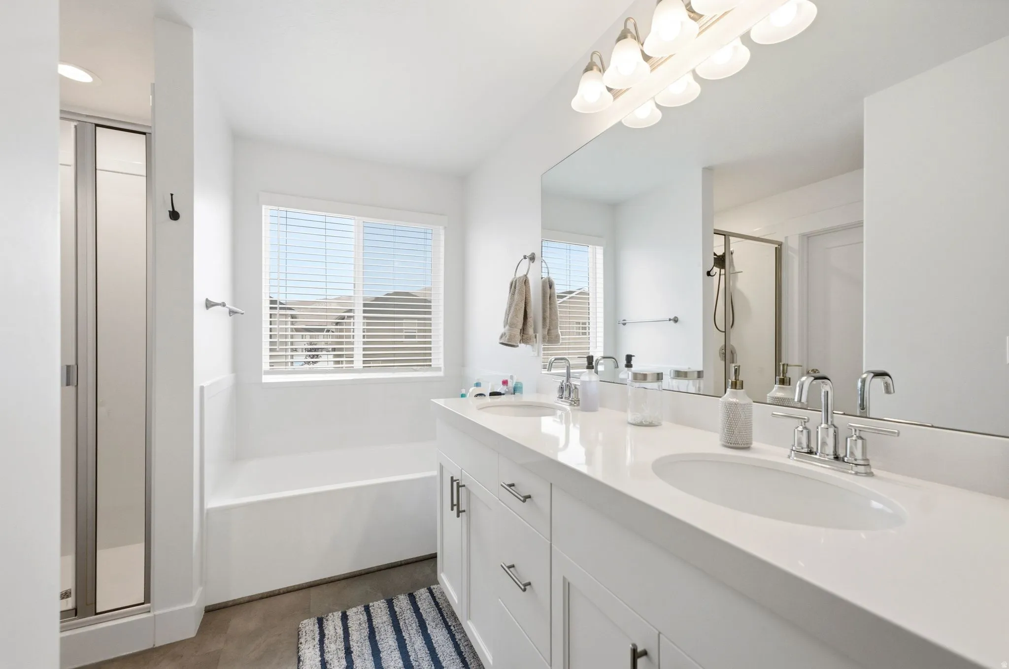 Dual vanity with white cabinetry and integrated sinks, complemented by chrome fixtures