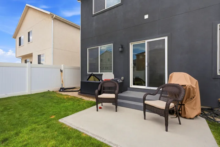 Private backyard with a concrete patio and direct access to the interior via a sliding glass door
