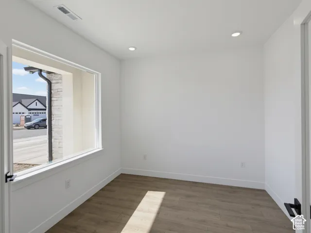 Interior space featuring wood-finish flooring, recessed lighting, and a large picture window