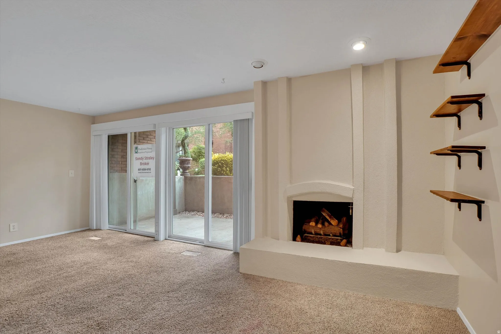 Built-in fireplace with a hearth, recessed lighting, and wall-mounted shelving