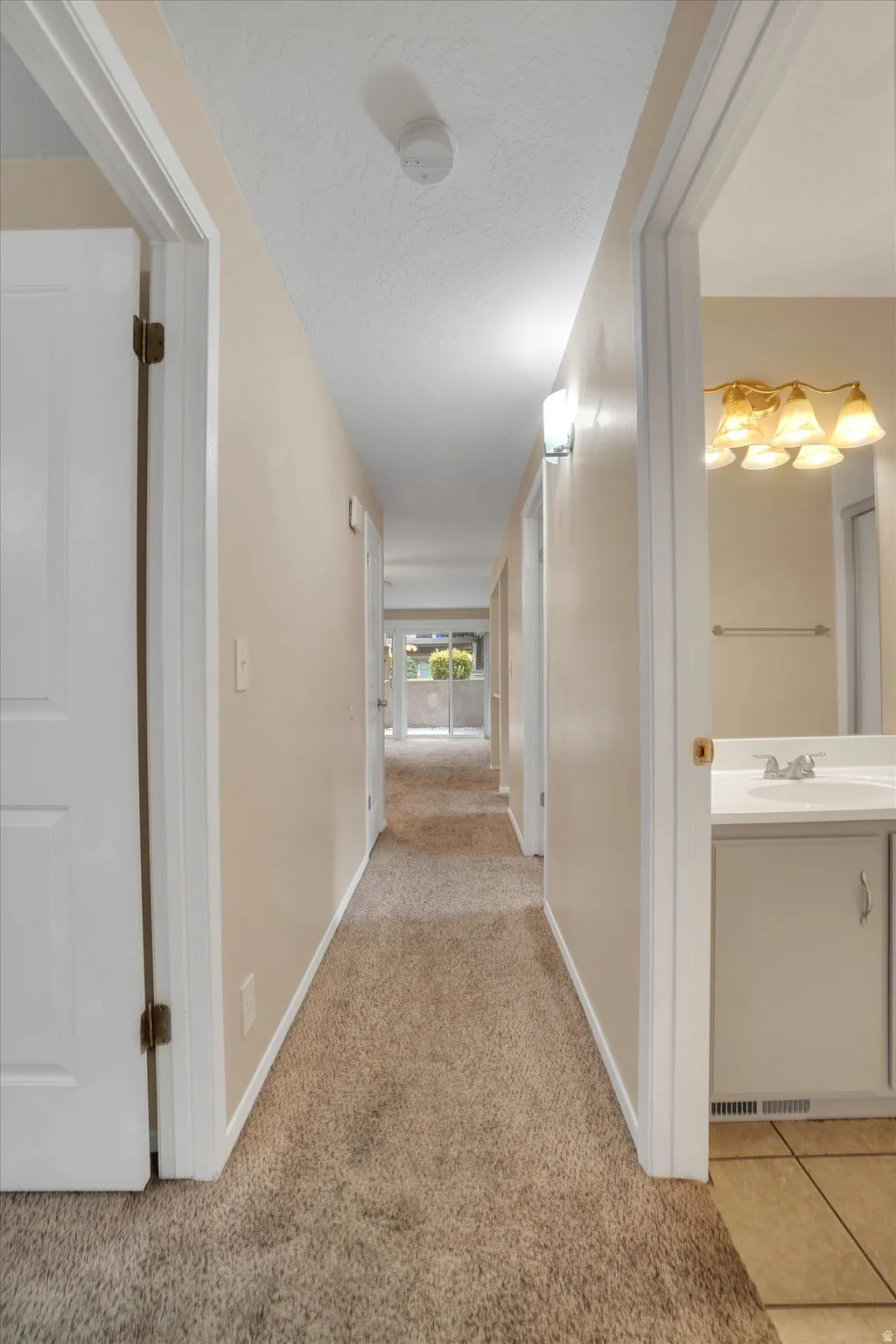 Hallway featuring carpet flooring, recessed lighting, and white panel doors