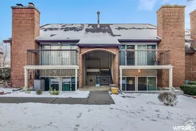 Brick exterior with multiple private balconies featuring metal railings